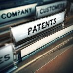 Innovative Company Concept Folder and focus on a tab with the word patents, blur effect. Concept of company innovation.